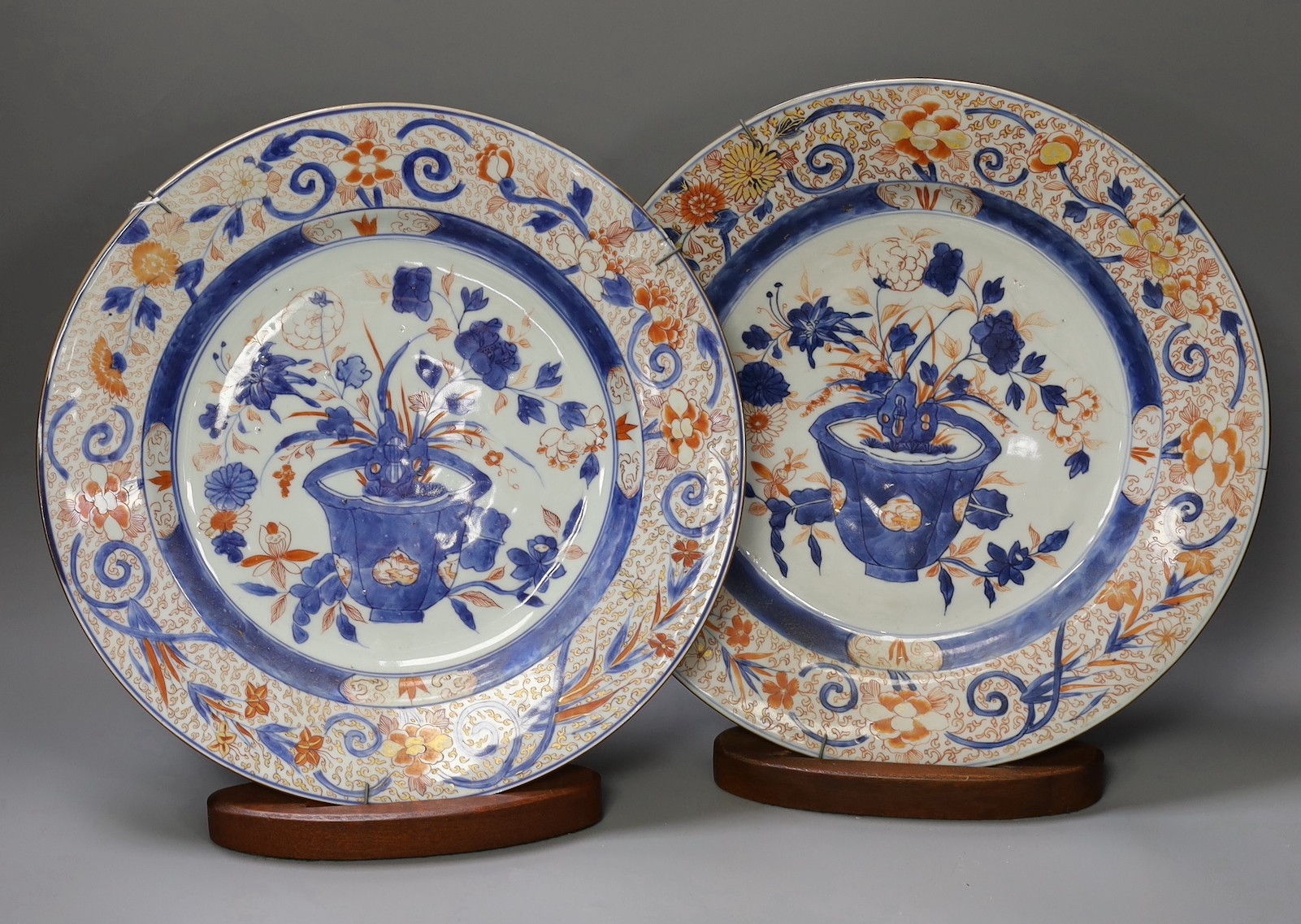 A pair of Chinese Imari dishes, Kangxi period, on wooden stands, 31 cms diameter., Provenance - D.C.Monk & Son, former dealers based in Kensington Church Street, London W8